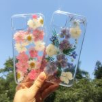 Real flower iPhone case with glitter accents and transparent silicone for iPhone 11, XR, XS, and more.