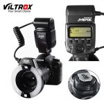 A professional Viltrox JY-670C Macro Ring Flash mounted on a Canon DSLR camera, with an illuminated ring and LCD display in a studio setting.